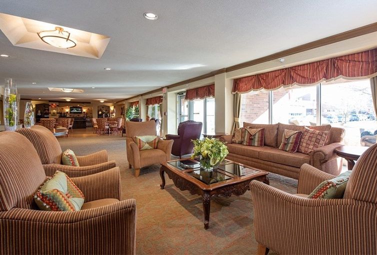 A spacious and elegantly furnished living room with comfortable seating and warm decor.