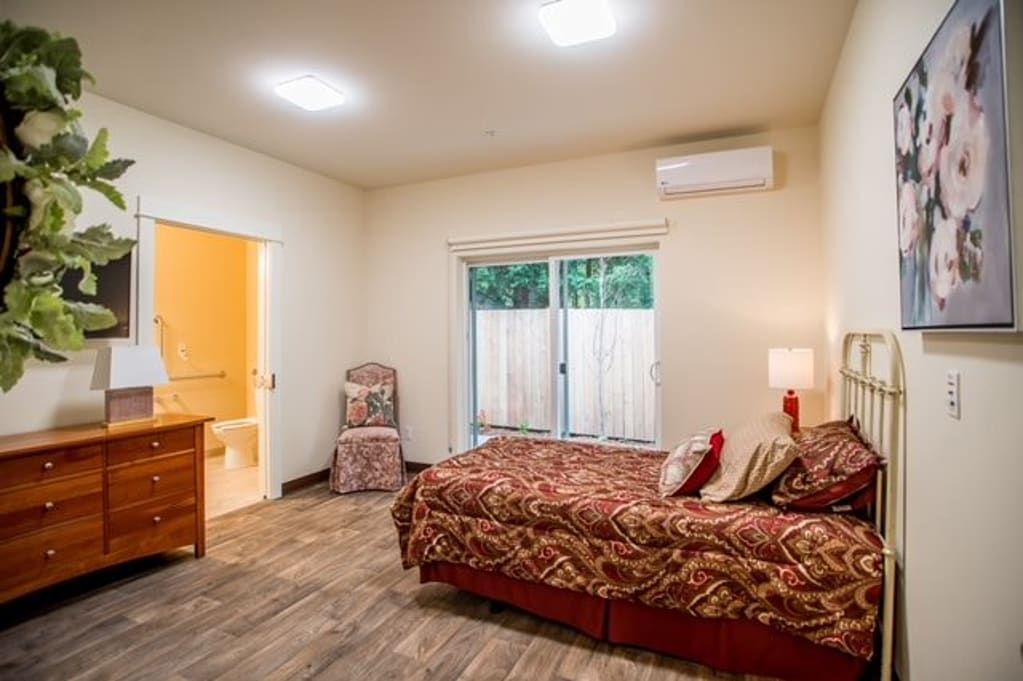 A cozy bedroom with stylish decor and modern lighting.