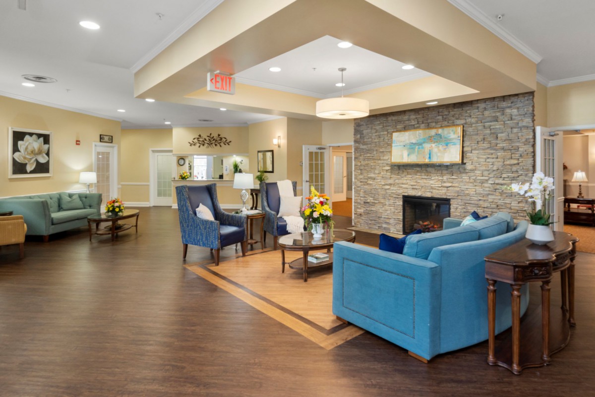 A cozy living room with elegant furniture and a warm fireplace.