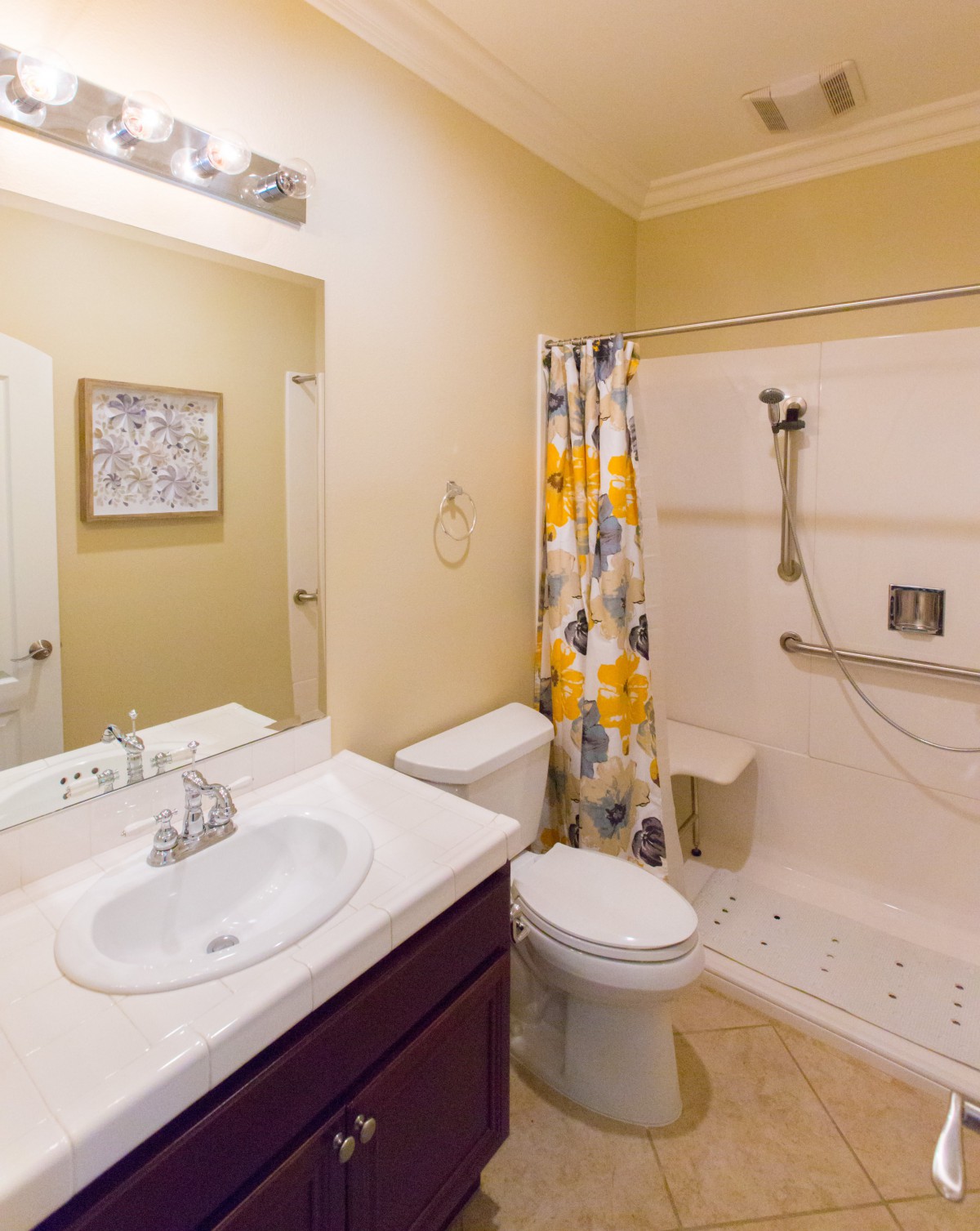 A modern bathroom with a shower, toilet, and sink.