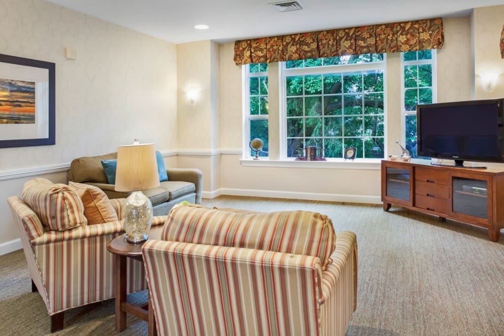 Cozy living room with comfortable seating and a large window.