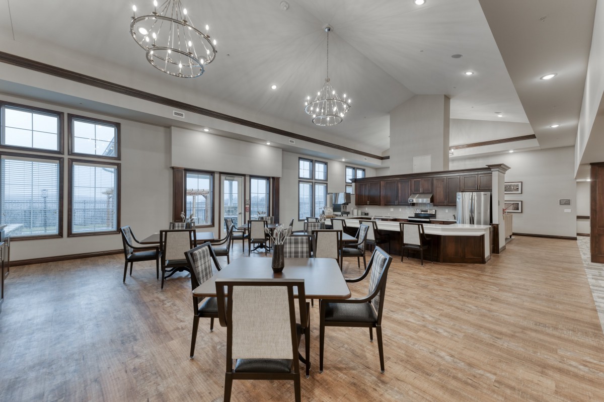 A modern dining area with elegant chandeliers and sleek furniture.