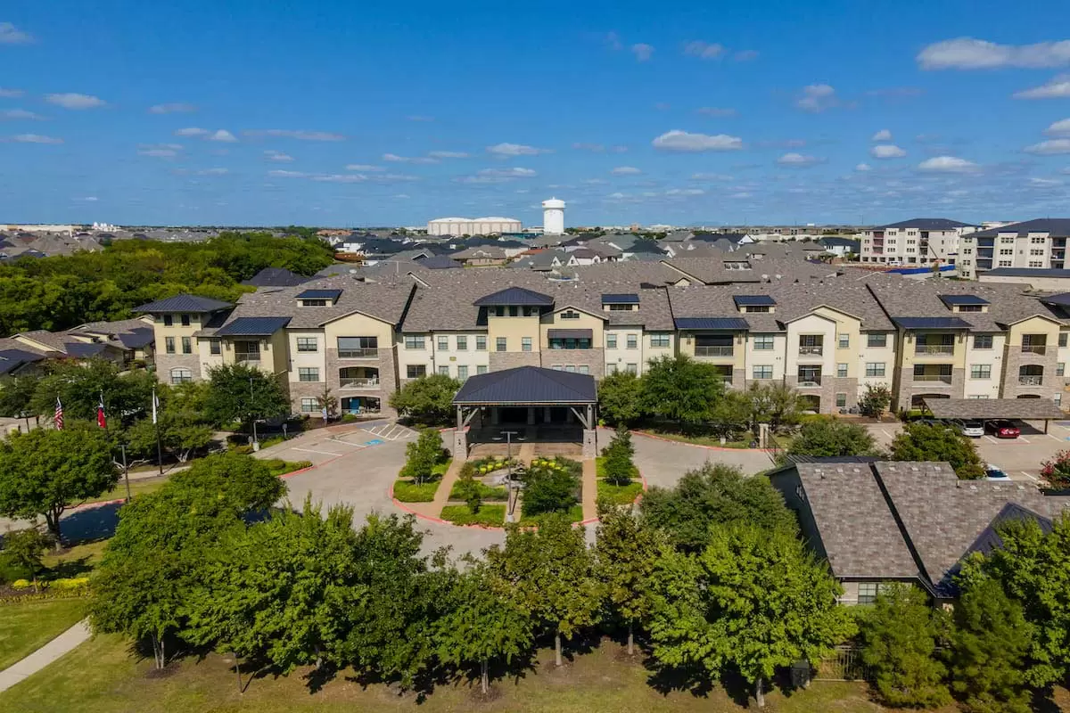 Aerial view of a residential apartment complex surrounded by trees.