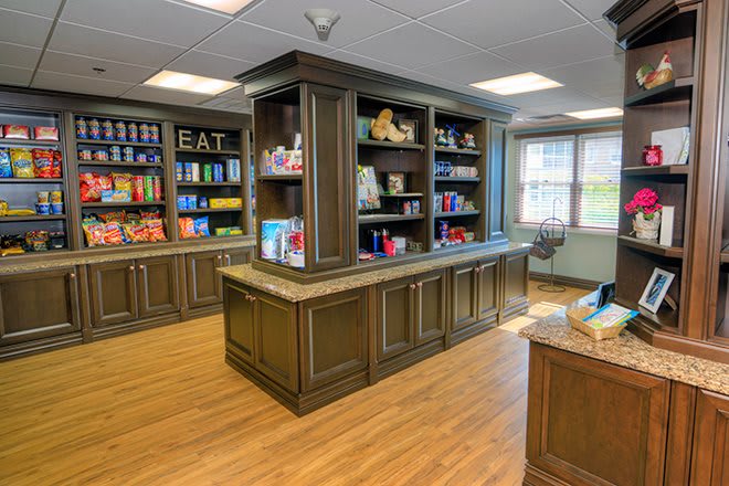 A cozy library interior with wooden bookshelves filled with books and decorative items.