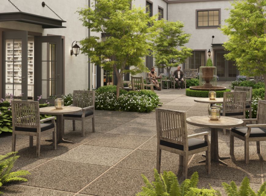 A peaceful courtyard with outdoor seating and lush greenery.