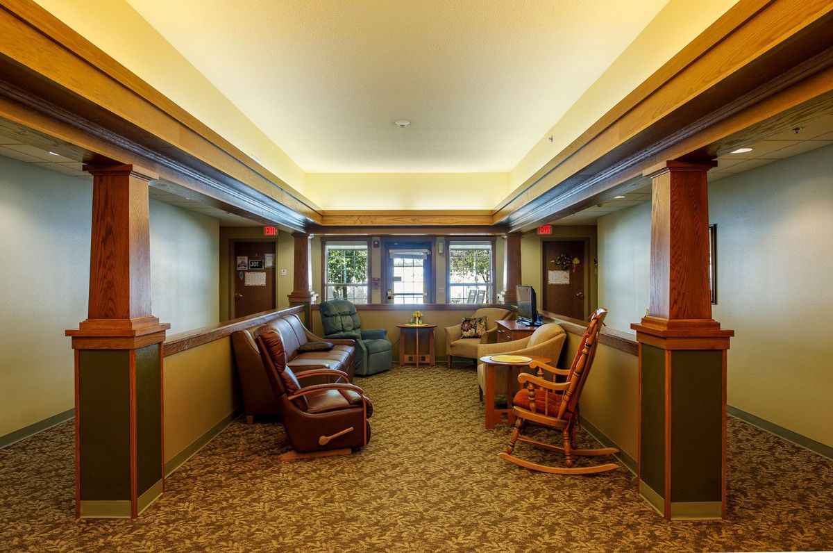 A cozy lounge area with comfortable seating and large windows.
