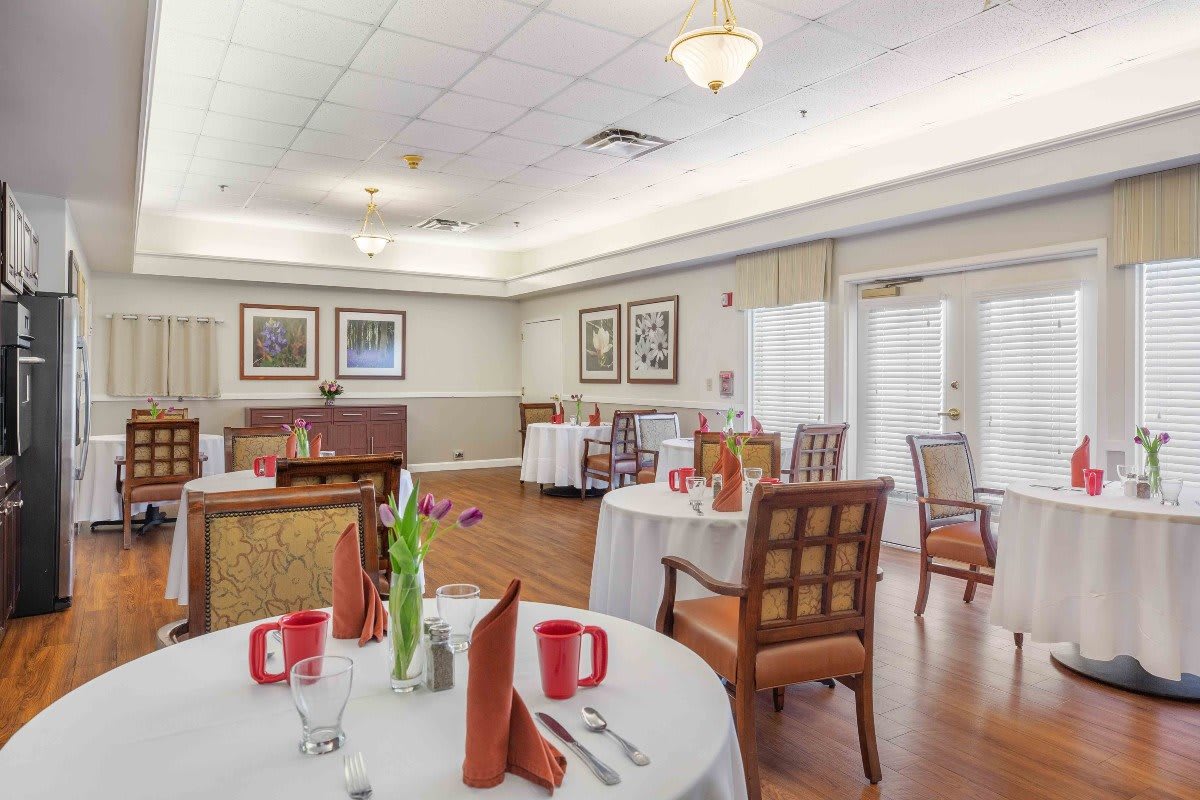 A well-appointed dining room with elegantly arranged tables and chairs, ready for guests.