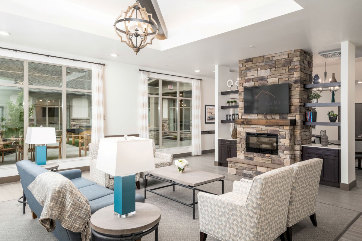 A modern living room with a fireplace and comfortable seating.