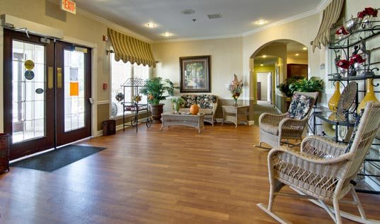 A welcoming lobby area with comfortable seating, decorative plants, and artwork on the walls.