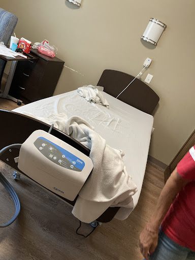 A view of a patient room with a hospital bed and medical equipment.