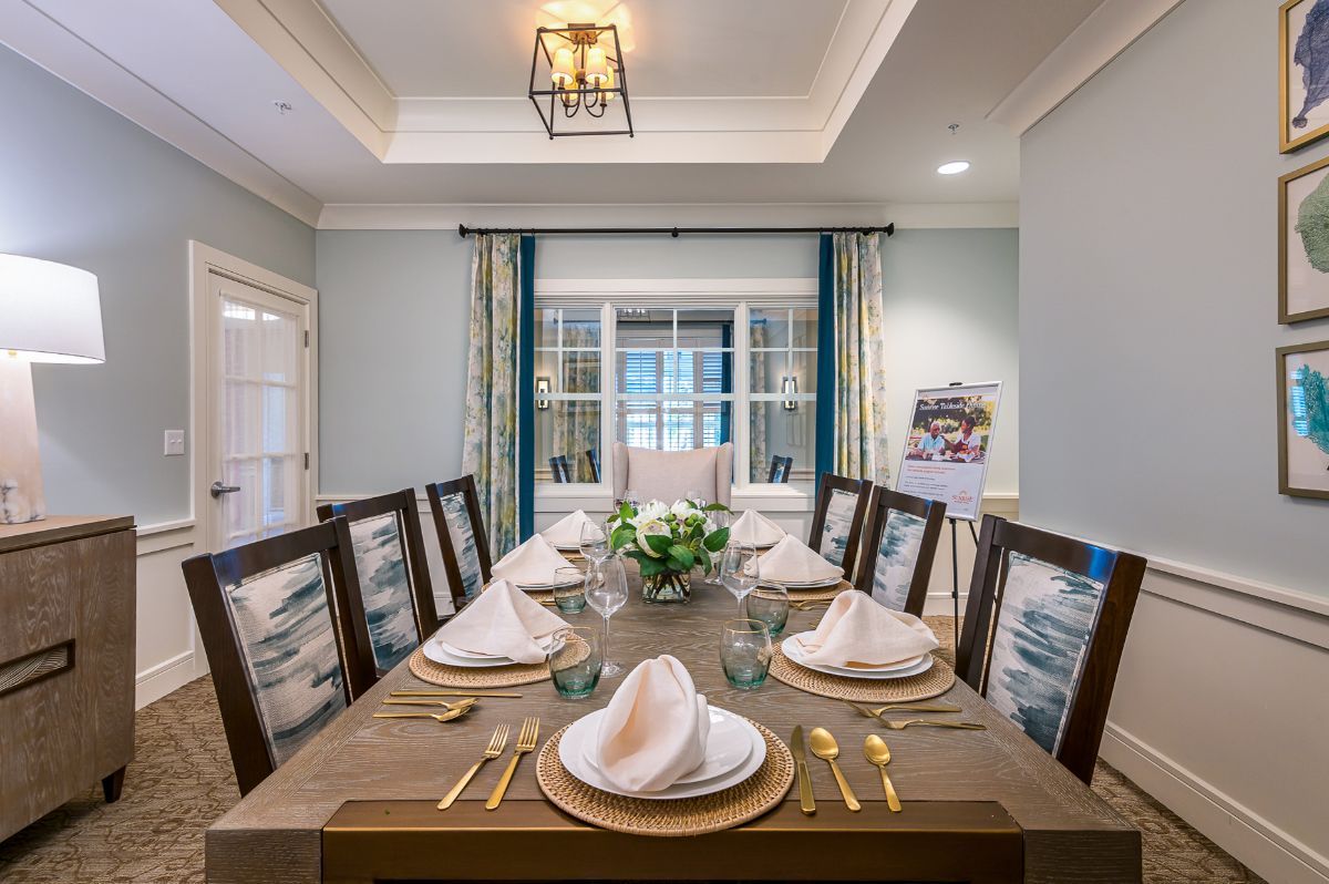A beautifully decorated dining room with a formal table setting and elegant decor.