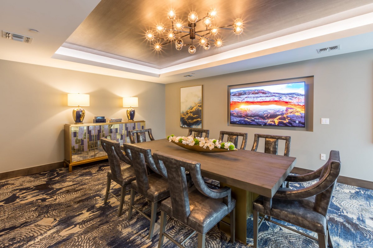 A modern dining room with elegant lighting and art on the walls.