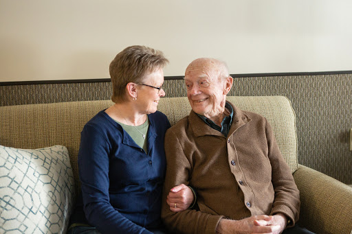 A heartwarming moment shared between an elderly couple, highlighting their affection and companionship.