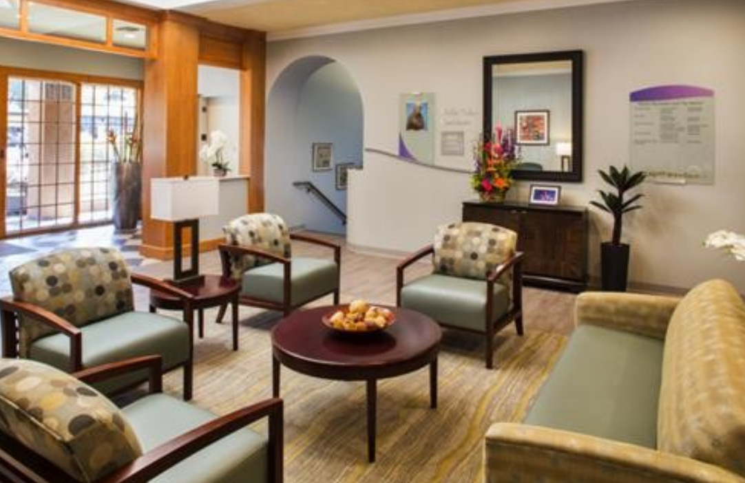 A comfortable waiting room with chairs and a coffee table.