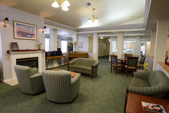 A cozy living room with sofas, chairs, and a table, featuring a warm and inviting interior decor.