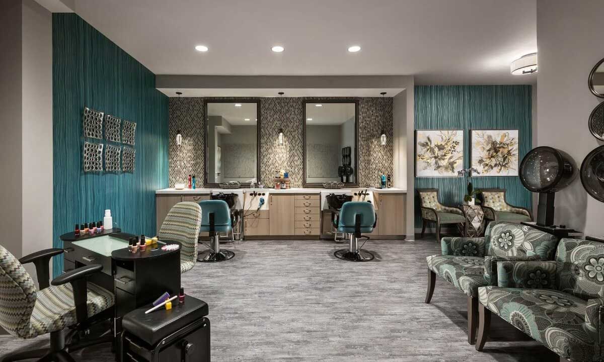 A modern hair salon with stylish interior design featuring mirrors, chairs, and elegant lighting.