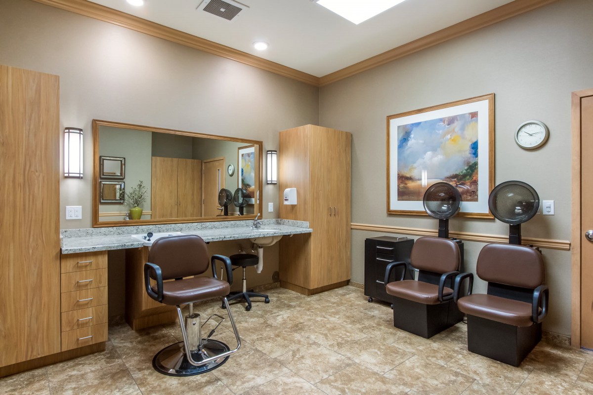 A well-equipped salon interior with styling chairs, mirrors, and drying stations.