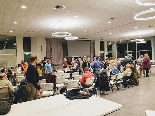 A community gathering taking place in a spacious indoor venue.