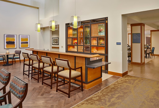 A modern bar area featuring elegant seating and ambient lighting.