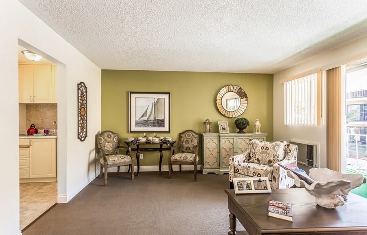 A cozy living room with elegant furniture and decorative elements.