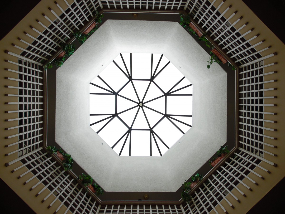 A geometric view of an octagonal ceiling with a glass structure.