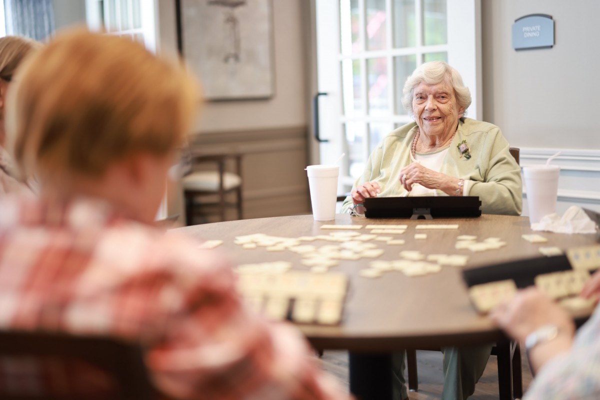 Seniors enjoying a board game together at a community center.