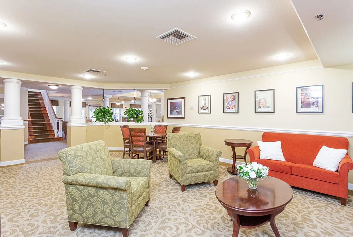 A cozy seating area with comfortable chairs and a table in a well-lit living room.