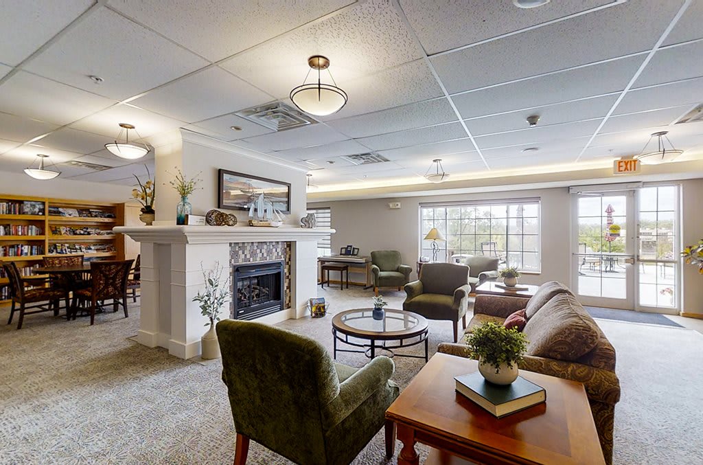 A cozy living room with modern decor featuring a fireplace and comfortable seating.