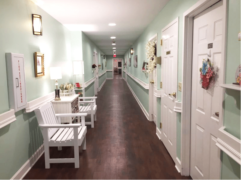A well-lit hallway with benches and decorative elements along the walls.