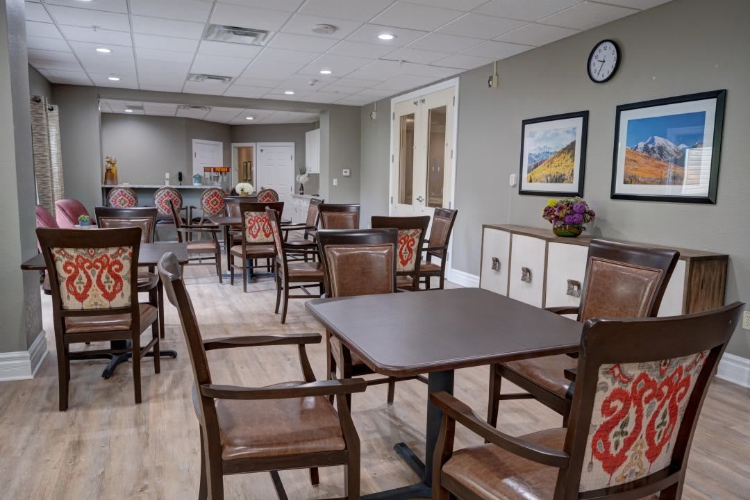 A cozy dining area with neatly arranged tables and chairs in a community facility.