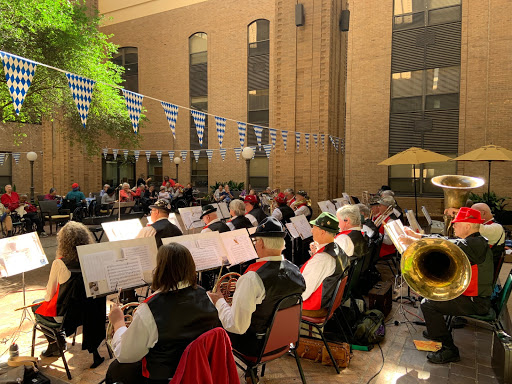 A lively outdoor performance by a band in traditional attire, showcasing community spirit and musical talent.