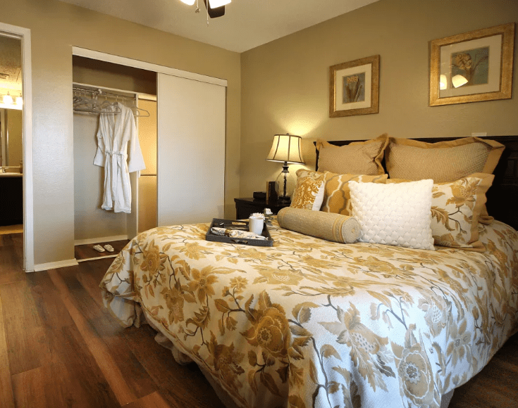 A cozy bedroom with elegant bedding and a warm ambiance.