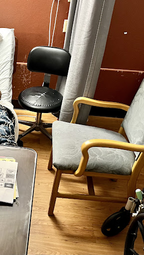 A cozy corner featuring different types of chairs in a room.