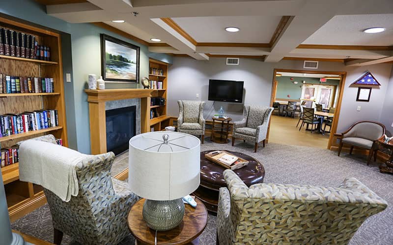 A cozy living room featuring a fireplace, comfortable seating, and a television.