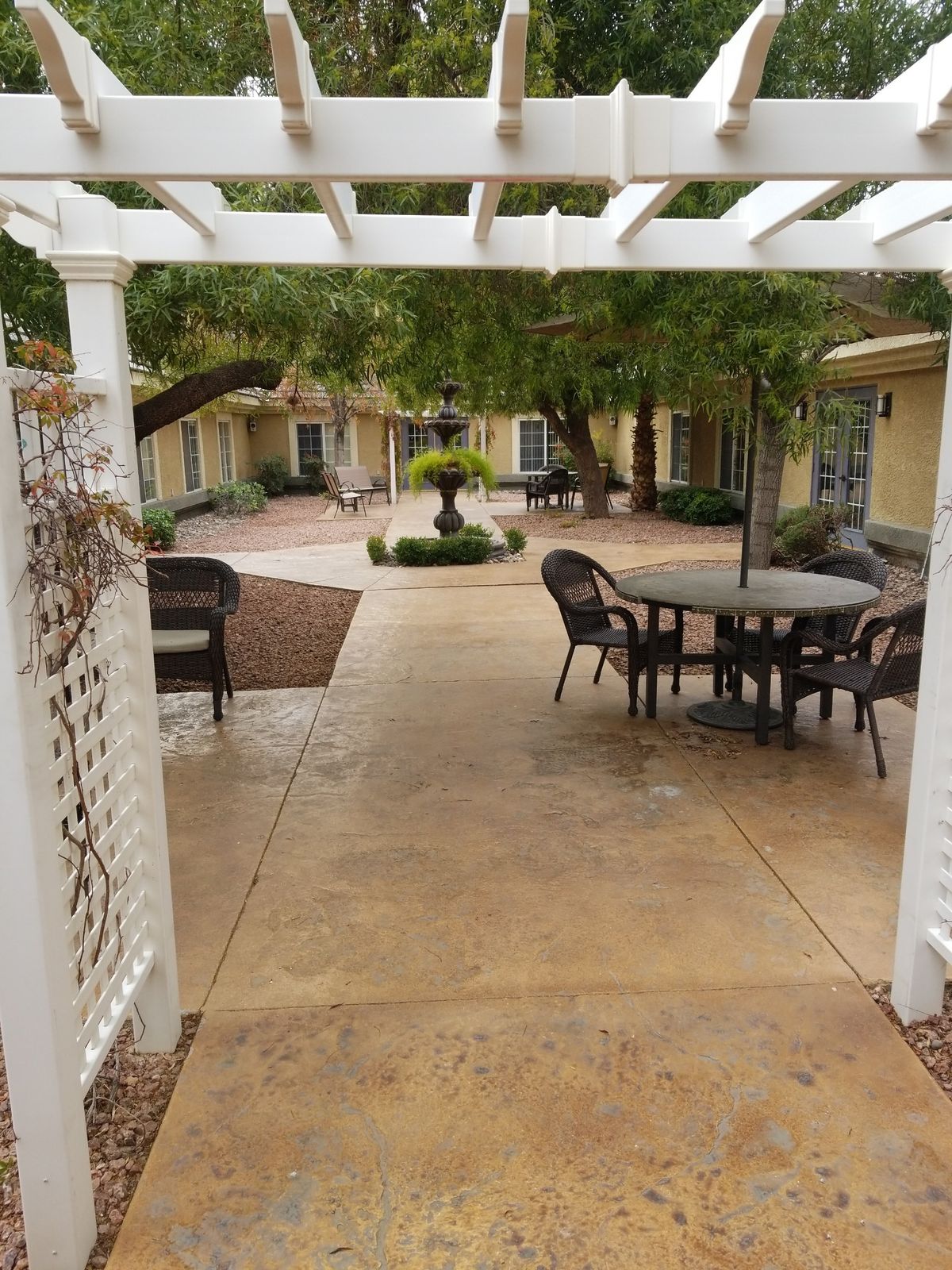 A serene courtyard with outdoor seating and lush greenery.