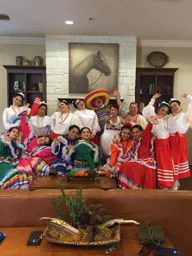 A vibrant group showcasing traditional dance attire in a joyful cultural celebration.