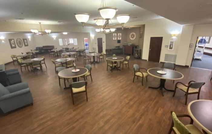Spacious dining area with multiple tables and warm lighting.
