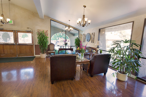 A welcoming and bright lobby space featuring comfortable seating, plants, and elegant decor.