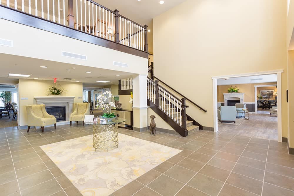 A modern lobby interior with a staircase and seating area.