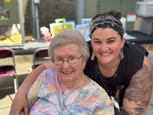 A joyful moment shared between a grandmother and her companion, showcasing the beauty of friendship across generations.