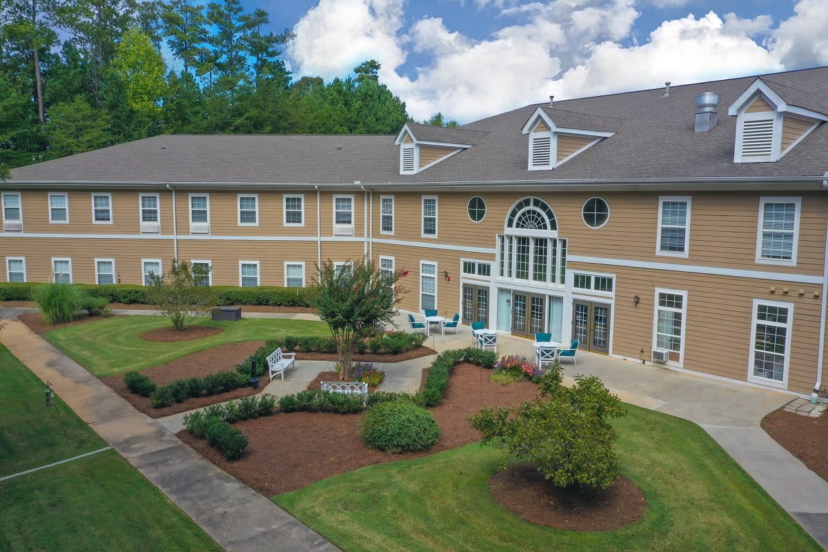 A residential building with a well-maintained garden and outdoor seating area.