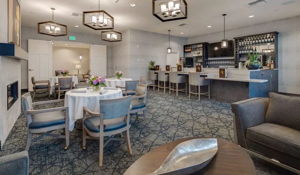 A modern dining and bar area with elegant seating and contemporary lighting.