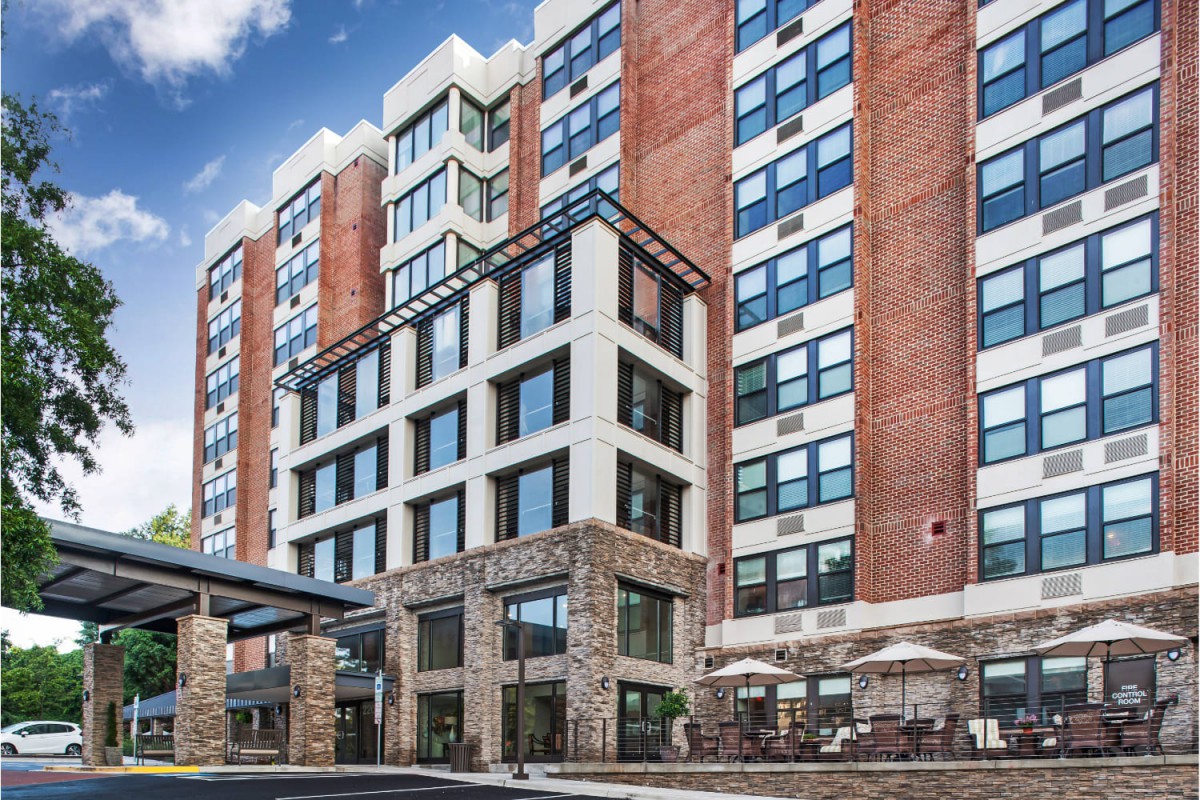 A modern hotel building with a mix of brick and glass architecture.