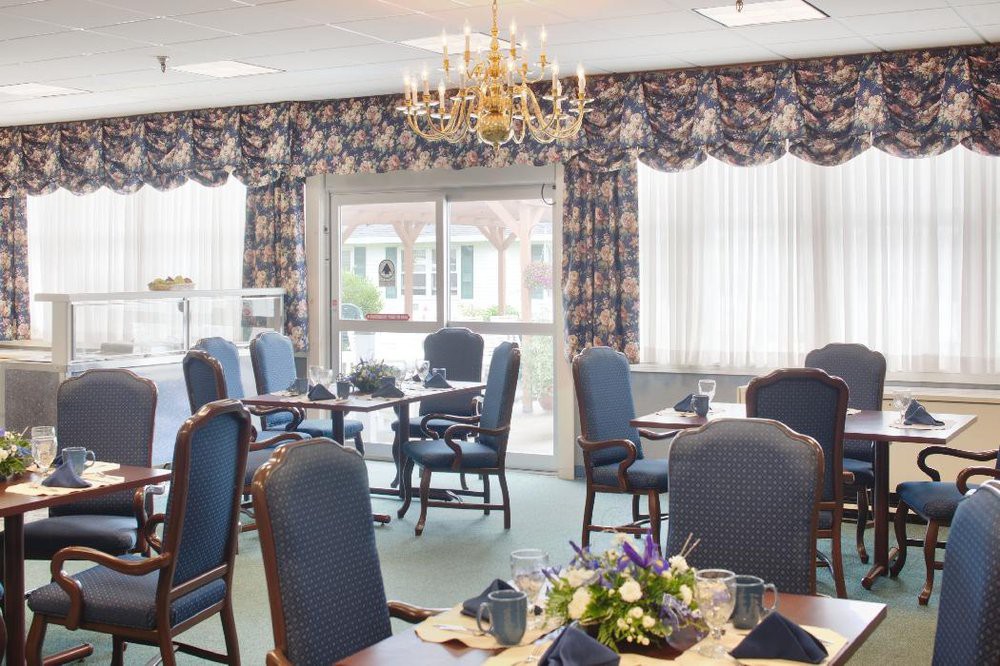 A well-decorated dining room with elegant furniture and floral arrangements.