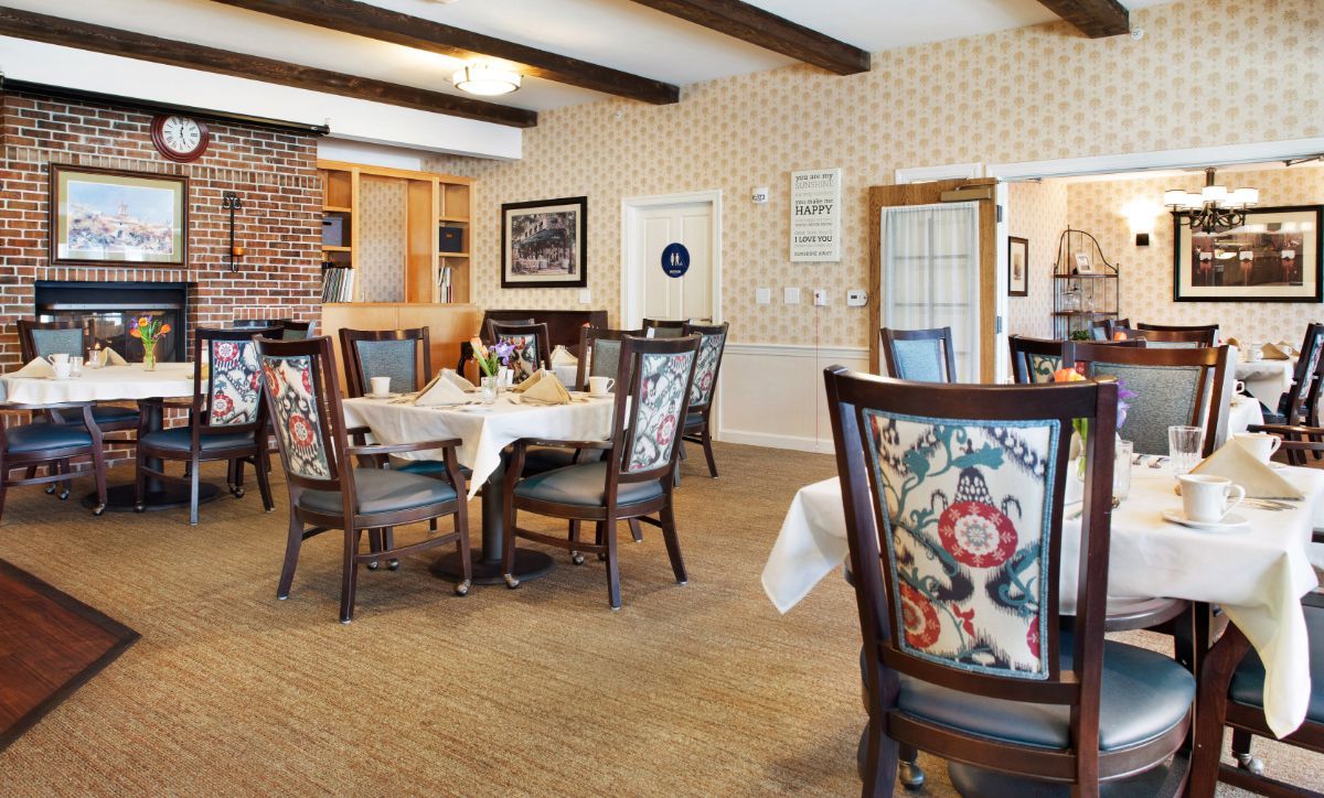 A cozy dining room with elegantly set tables and traditional decor.