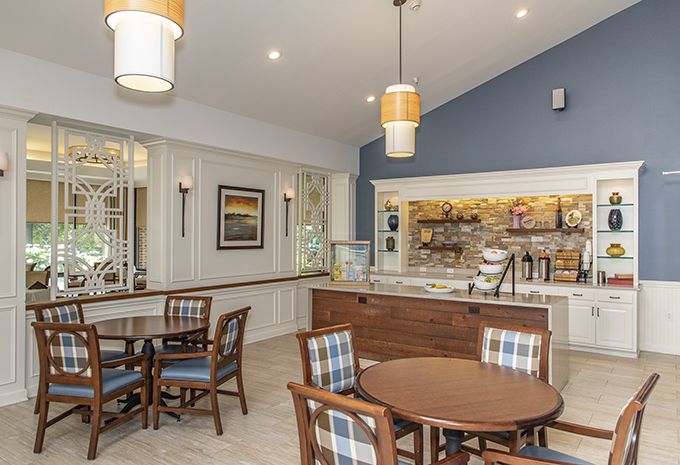 A cozy cafe interior featuring tables and chairs, with a focus on modern decor and lighting.