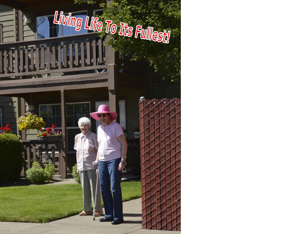 Two elderly women enjoying a sunny day in the garden.