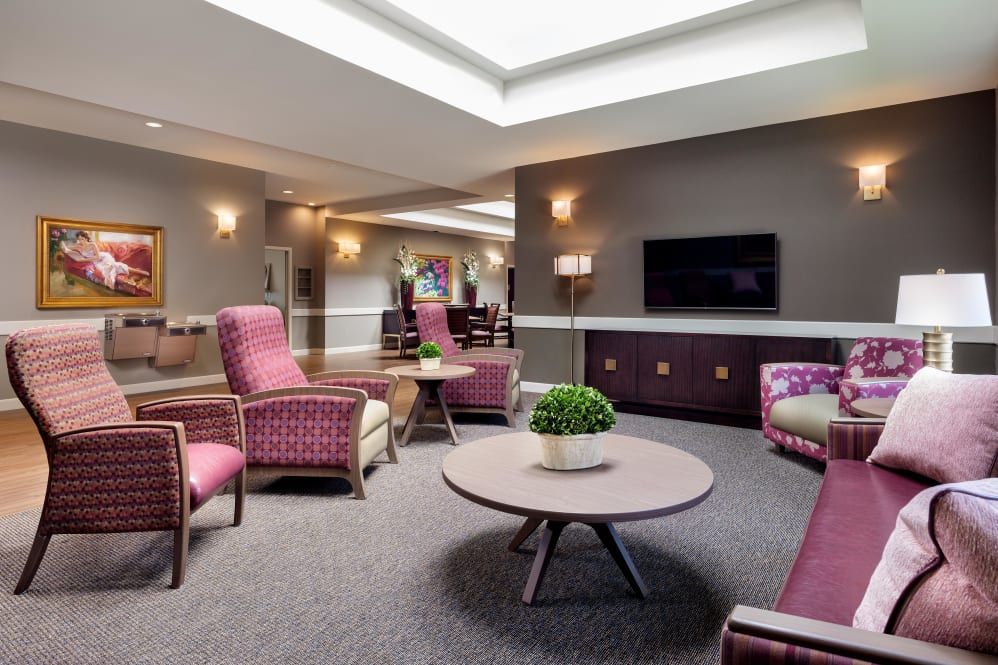 A modern lounge area with comfortable seating and a television.