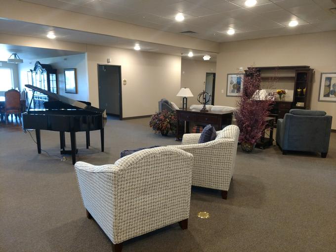 Spacious lobby with comfortable seating and a piano.