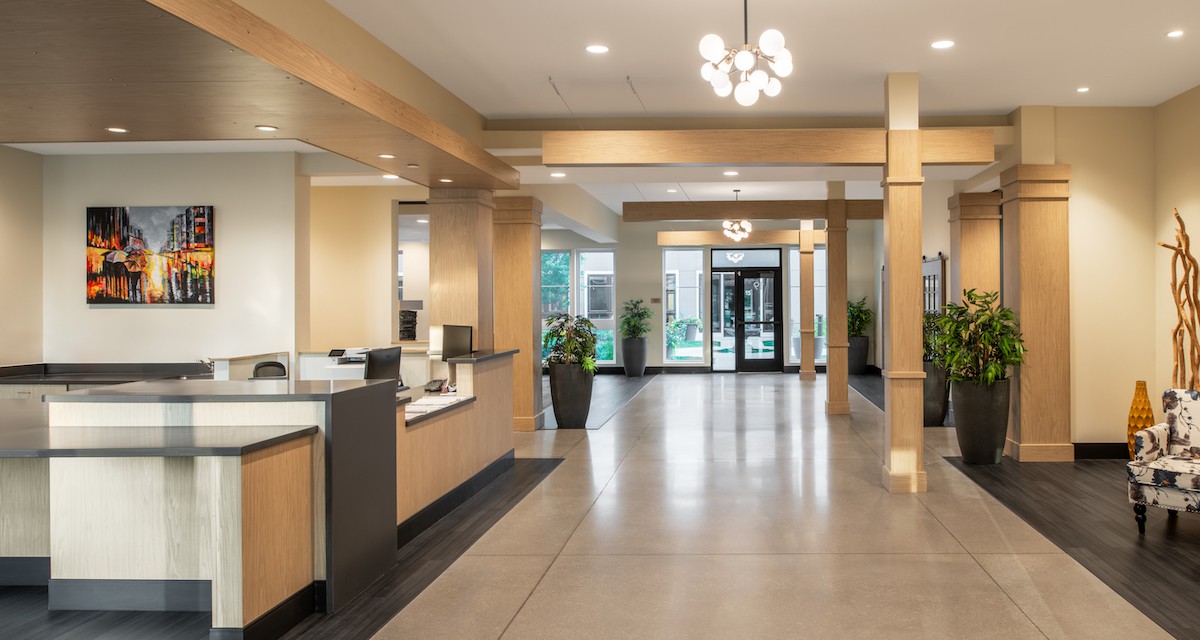 A modern hotel lobby with a sleek reception area and contemporary lighting.